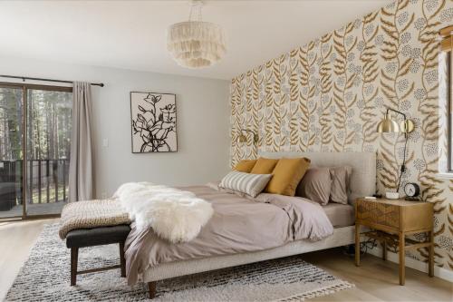 a bedroom with a large bed and a window at Family Cabin With Hot Tub, Games, & Forest Views in Clio