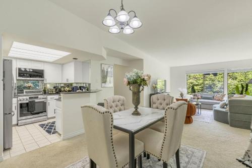 a kitchen and living room with a table and chairs at Perch - Bellevue Retreat in Bellevue
