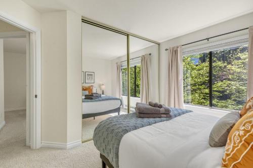 a bedroom with a bed and a large window at Perch - Bellevue Retreat in Bellevue