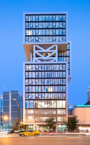 a building with a yellow car parked in front of it at Godfrey Hotel Chicago in Chicago