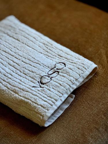 a white towel sitting on top of a table at YOSO Tenerife in Acantilado de los Gigantes