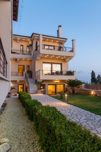 a large house with a walkway in front of it at Ikosapartments -home 3-4 in Perdika