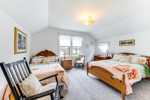 a bedroom with two beds and a chair at Twin Lakes Cottage Walk to Elizabeth Lake! in Twin Lakes
