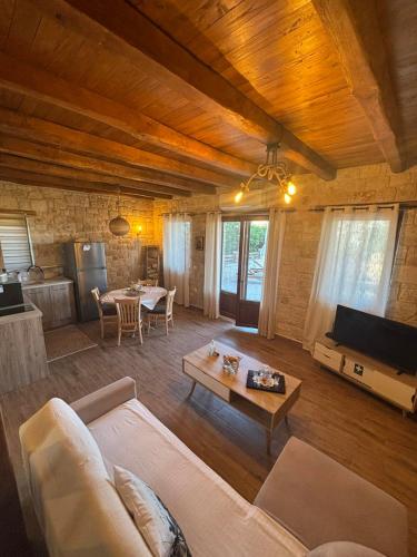 a living room with a couch and a table at Luxury stone villas in Afitos St'aloni in Kassandria