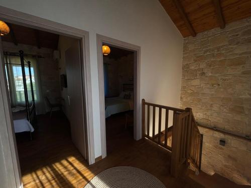 a hallway with a staircase and a room with a bed at Luxury stone villas in Afitos St'aloni in Kassandria