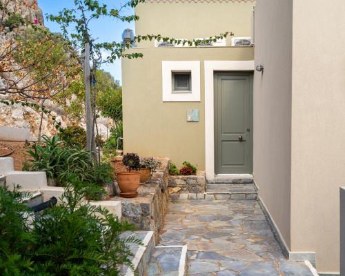 a door to a house with a stone walkway at Blue View Villas in Stalida