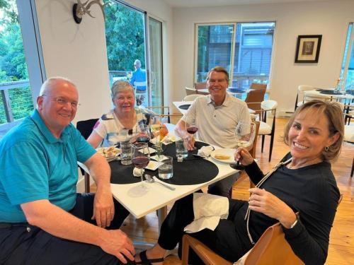 a group of people sitting at a table with wine glasses at Fire Mountain in Highlands