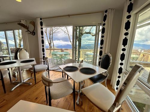 a room with a table and chairs and a large window at Fire Mountain in Highlands