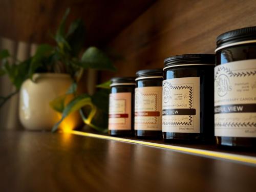 a row of jars sitting on a shelf with a plant at YOSO Tenerife in Acantilado de los Gigantes
