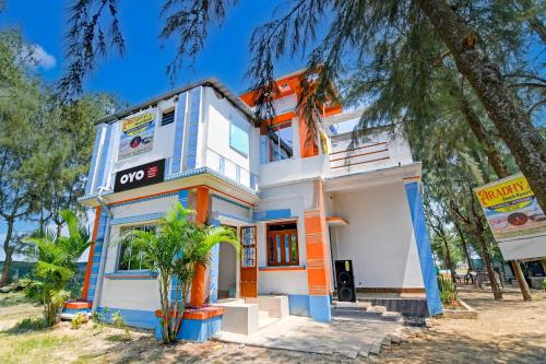 a house with an orange and white at Hotel O Aradhya Beach Resort in Mandarmoni
