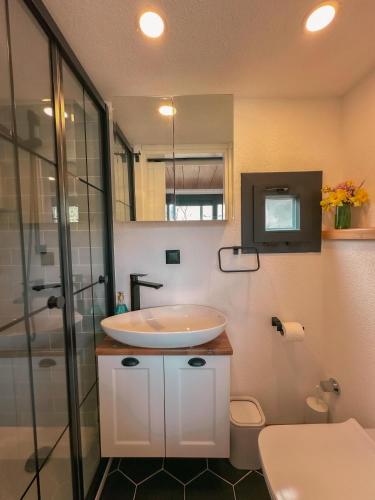 a bathroom with a white sink and a shower at Marmaris Tiny House Olea Gökbel in Marmaris