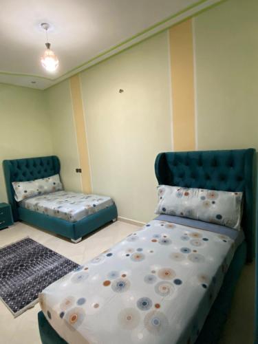 a bedroom with a bed and a couch in it at Family Apartment in City Centre in Douar Oulad Mhammed