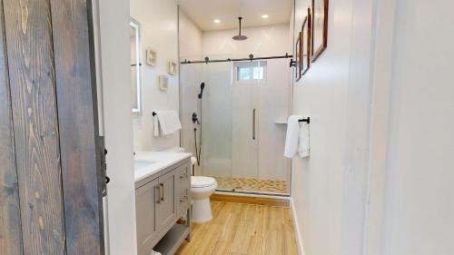 a white bathroom with a toilet and a shower at The Beach House in Ocean City