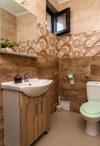 a bathroom with a sink and a toilet at Casa Daymar 2 Mai in 2 Mai