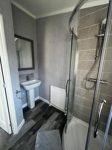 a bathroom with a shower and a sink at Sunnydene Country Park in South Cave