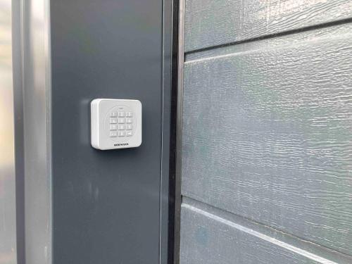 a door with a remote control on the side of it at Taminimaison in Laval