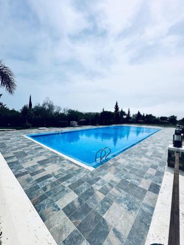 a large blue swimming pool with a tile floor at Great stay at BELLA VISTA CaboNegro in Cabo Negro