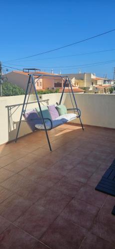 a swing on top of a balcony at Ohana in Olhão