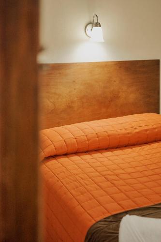 Postel nebo postele na pokoji v ubytování Hotel Cervantino