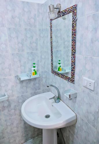 a bathroom with a sink and a mirror at Ghazala Oasis Hotel in Dahab