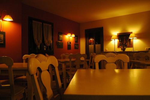 a dining room with tables and chairs and lights at Hotel Areulo in Cerler