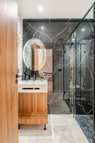 a bathroom with a sink and a shower at Cosy Maarif 431 by Viva Stay in Maarif