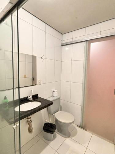 a bathroom with a toilet and a sink at Golden Hotel in Vilhena