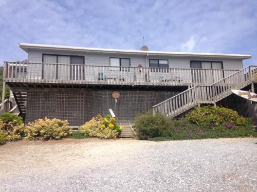 a house with a deck and a balcony at Sunset Holiday Villas in Arthur River