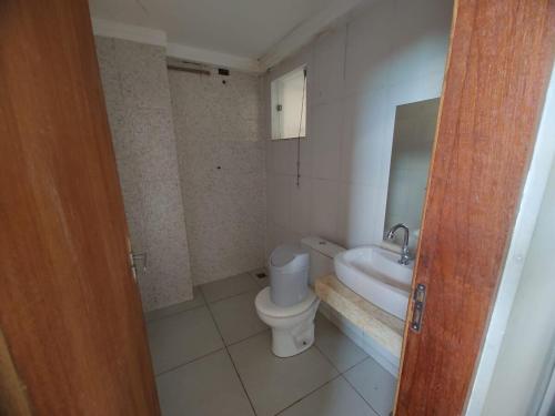 a small bathroom with a toilet and a sink at Chacara Ibiuna - Incrivel in Ibiúna