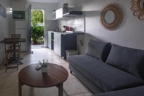 a living room with a couch and a table at Tiki Ora lodge - MOANA in Bora Bora