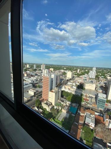 a view of a city from a window at Semipiso Skyline Elegante y lujoso, Las Lomitas in Lomas de Zamora