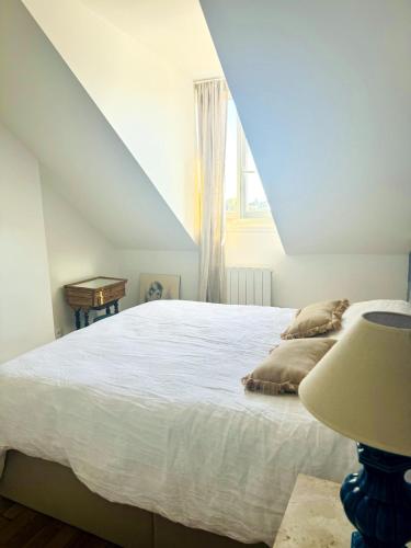 une chambre avec un grand lit blanc et une fenêtre dans l'établissement Meudon Jewel Near Paris, à Meudon