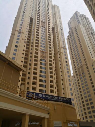 a tall building with a sign in front of it at AHLAN Dubai Marina JBR in Dubai