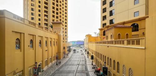 an empty street in a city with tall buildings at AHLAN Dubai Marina JBR in Dubai