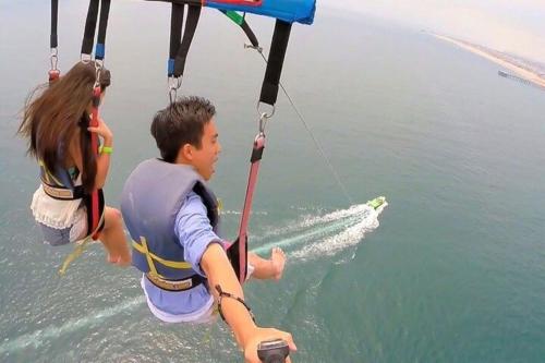 a man and a girl are on a board in the water at AHLAN Dubai Marina JBR in Dubai