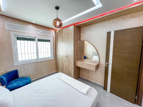 a bedroom with a bed and a window and a desk at Visit Chamal - Raihana in Oued Laou