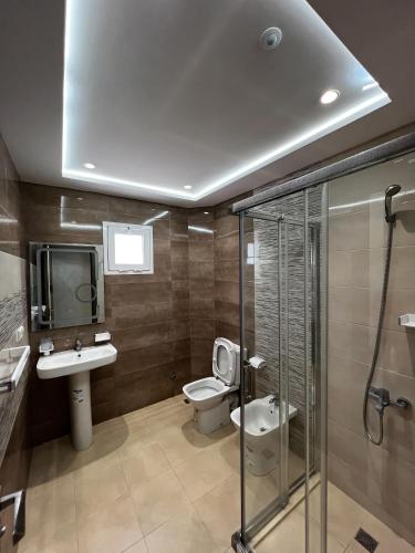 a bathroom with a toilet and a sink and a tv at Visit Chamal - Raihana in Oued Laou