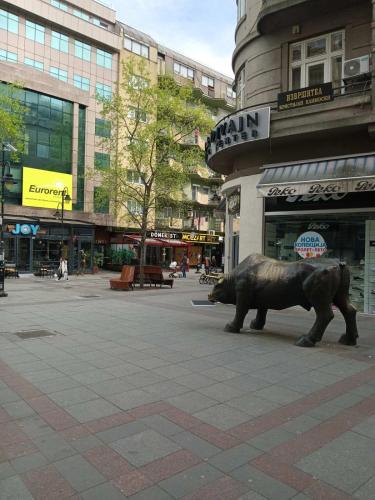 a statue of a bear in the middle of a street at Lovely square apartment Purple Velvet 43 Macedonia Stree in Skopje