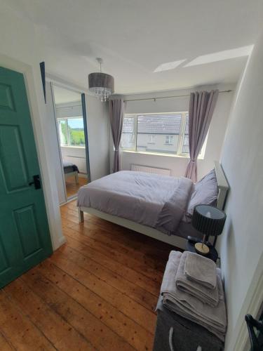 a bedroom with a bed and a green door at 26 Orchard House, Donegal town, F94WOH7 in Donegal