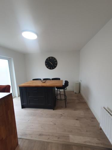 a room with a desk and a clock on the wall at 26 Orchard House, Donegal town, F94WOH7 in Donegal
