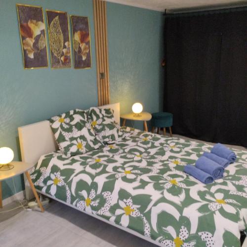 a bedroom with a bed with a flowered comforter at House 20 minutes from Geneva & beaches in Saint-Cergues