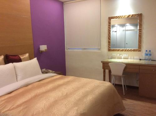 Postel nebo postele na pokoji v ubytování 紫園旅社Purple Garden Hotel