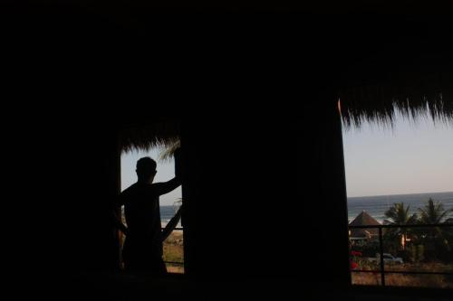 a man standing in the doorway of a building at Casa Euskondido in Tlachicón