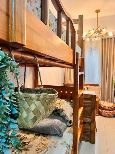 a bunk bed with a basket on top of it at SMDC Green 2 Staycation, The Traditional & Modern Fusion Condo in Pasong Bayog