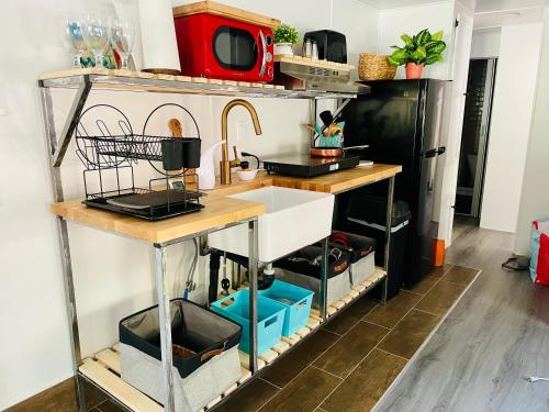 a kitchen with a sink and a counter at Sequoia Pine View Trailer Featured on HGTV in Wofford Heights