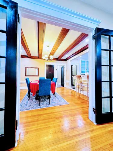 a dining room with a red table and blue chairs at Linwood Paradise Home in Buffalo