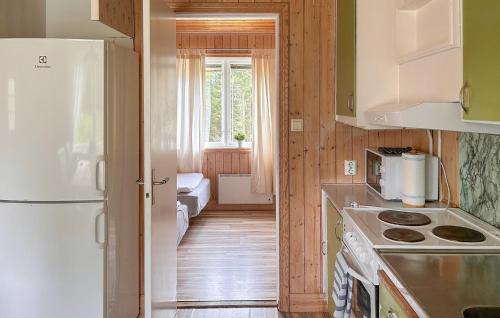 a kitchen with a white refrigerator and a window at Haren in Fegen
