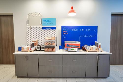 a counter in a room with boxes of donuts at Holiday Inn Express & Suites Waco Downtown by IHG in Waco