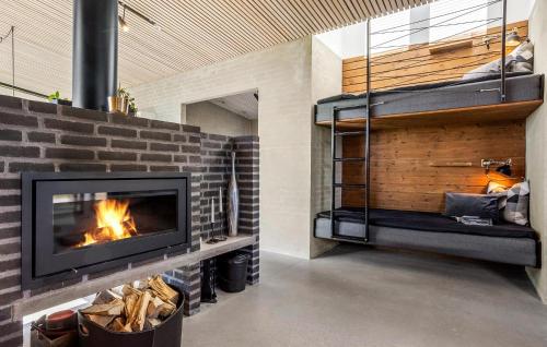 a fireplace in a living room with a brick wall at Two-Bedroom Holiday Home In Vinderup in Vinderup