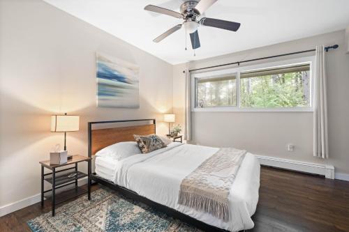 a bedroom with a bed and a ceiling fan at Modern Lodge on 6 acres - 15 mins to Camelback in Cresco